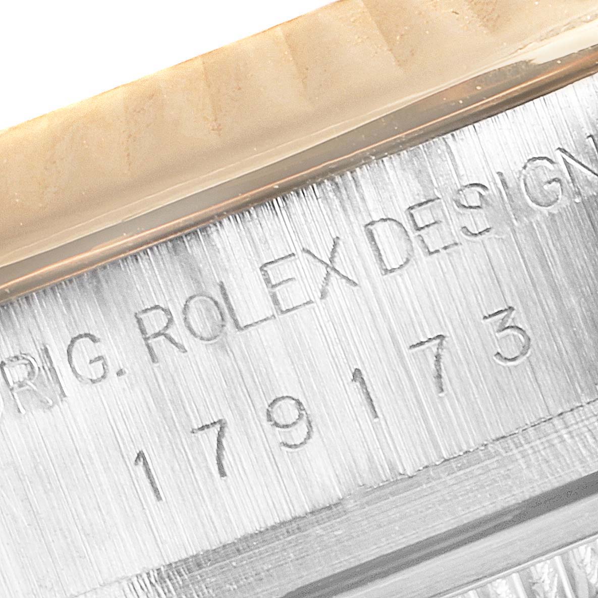This close-up image shows the engraved serial number and part of the design of the Rolex Datejust 179173 Women's Steel and Gold (two tone) Mother of Pearl Dial 179173 Women's Steel and Gold (two tone) Mother of Pearl Dial watch.