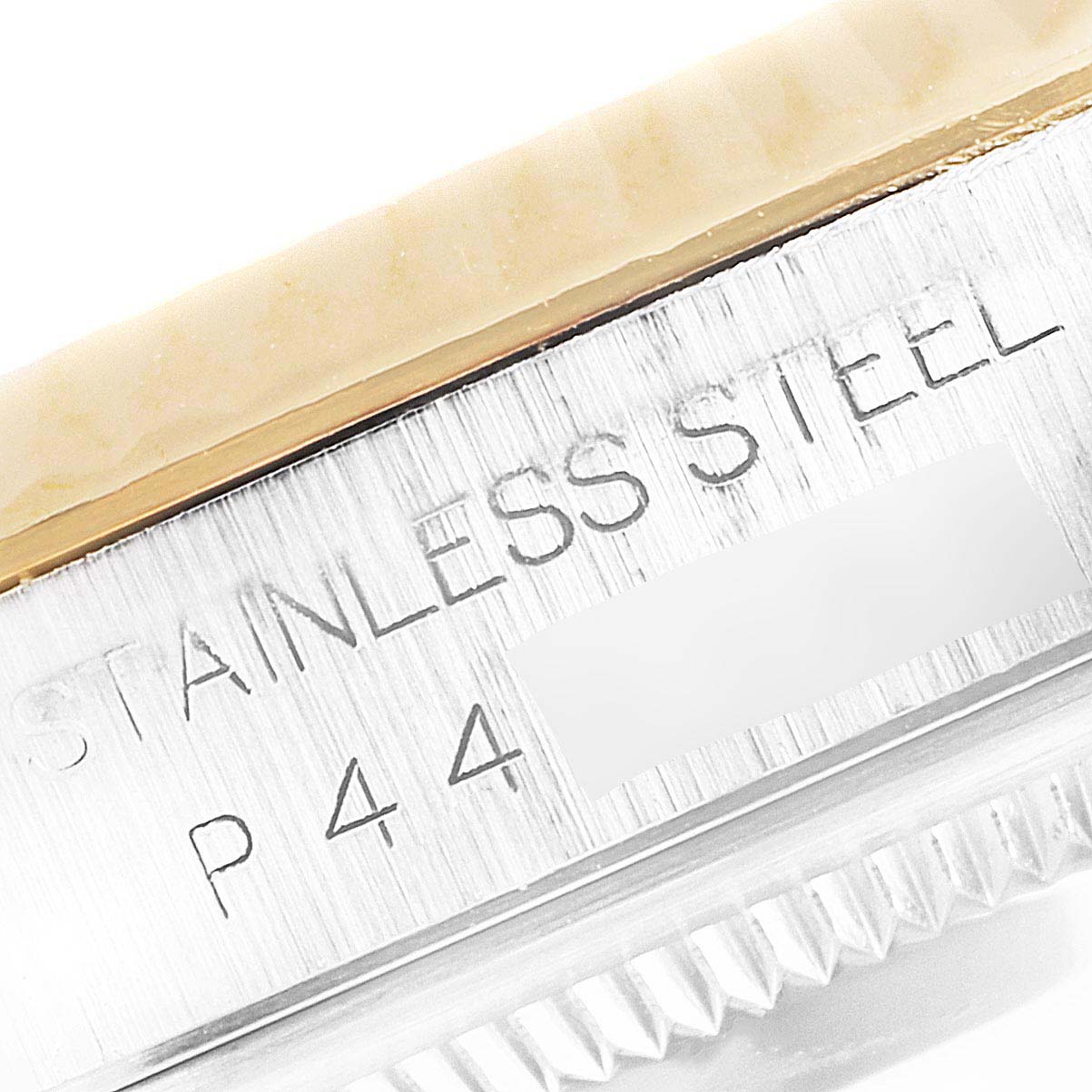 This close-up angle of the Rolex Datejust 16233 Men's Steel and Gold (two tone) Silver Dial 16233 Men's Steel and Gold (two tone) Silver Dial watch shows the engraved "STAINLESS STEEL" text and part of the watch's bezel.