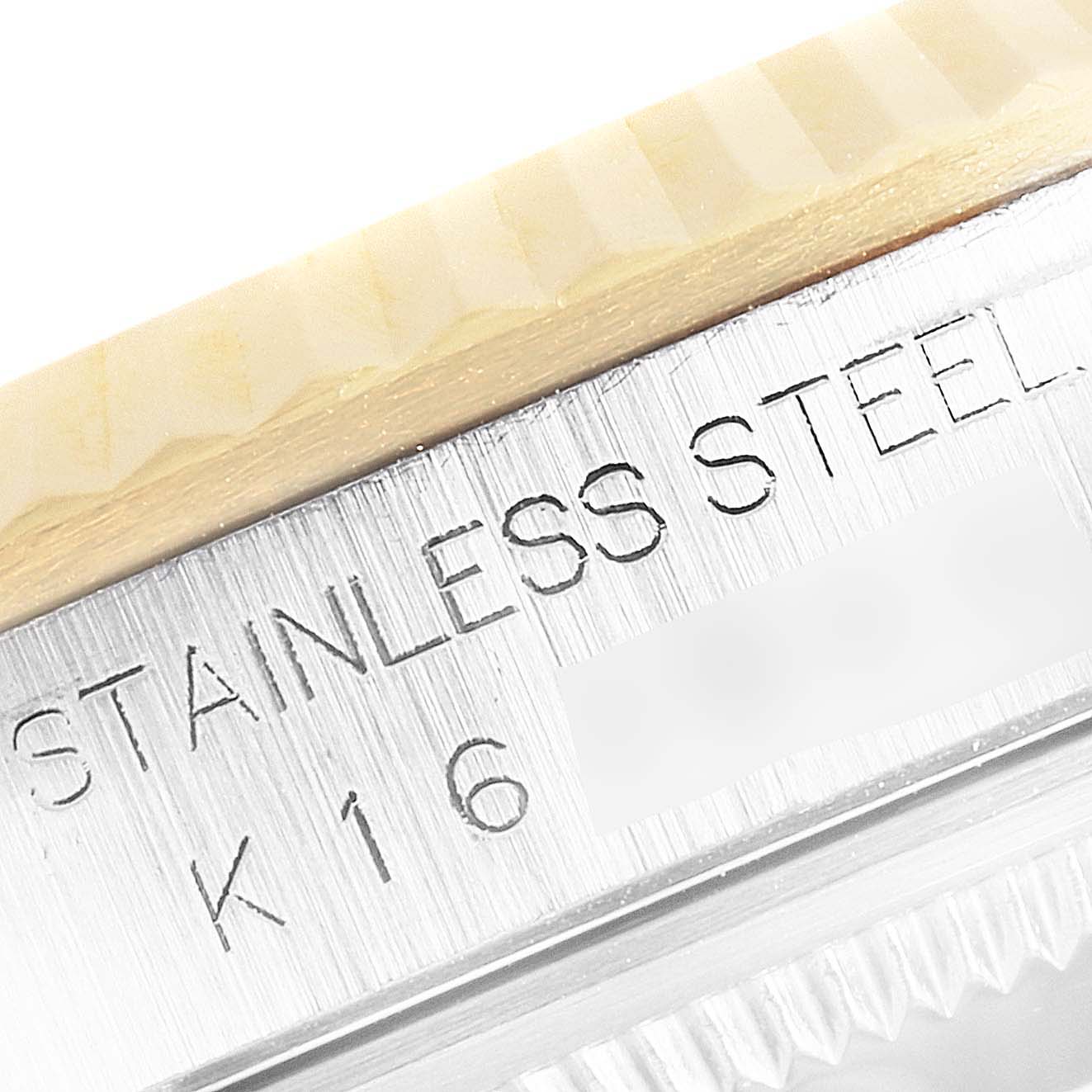 This close-up shows the side view of the bezel and part of the stainless steel case of a Rolex Datejust 16233 Men
s Steel and Gold (two tone) White Dial 16233 Men
s Steel and Gold (two tone) White Dial watch.