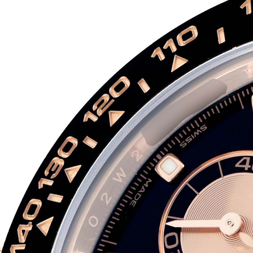 The image shows a partial view of a Rolex Daytona 116515 Men
s Rose Gold Black Dial watch focusing on the bezel and part of the dial.