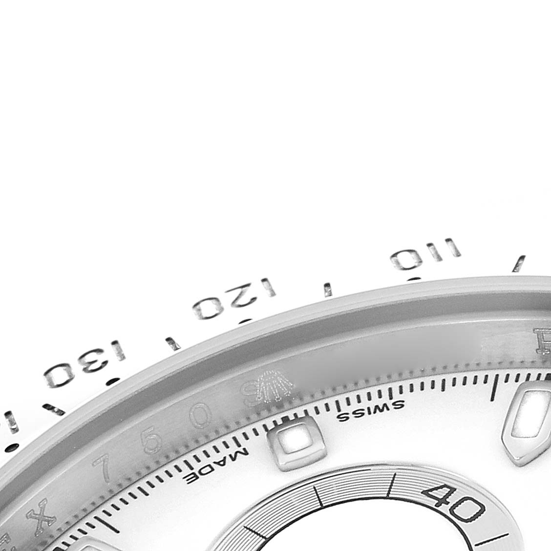 The image shows a close-up of the bezel and dial edge of a Rolex Daytona 116520 Men
s Stainless Steel White Dial, highlighting the tachymeter scale and part of the markers.