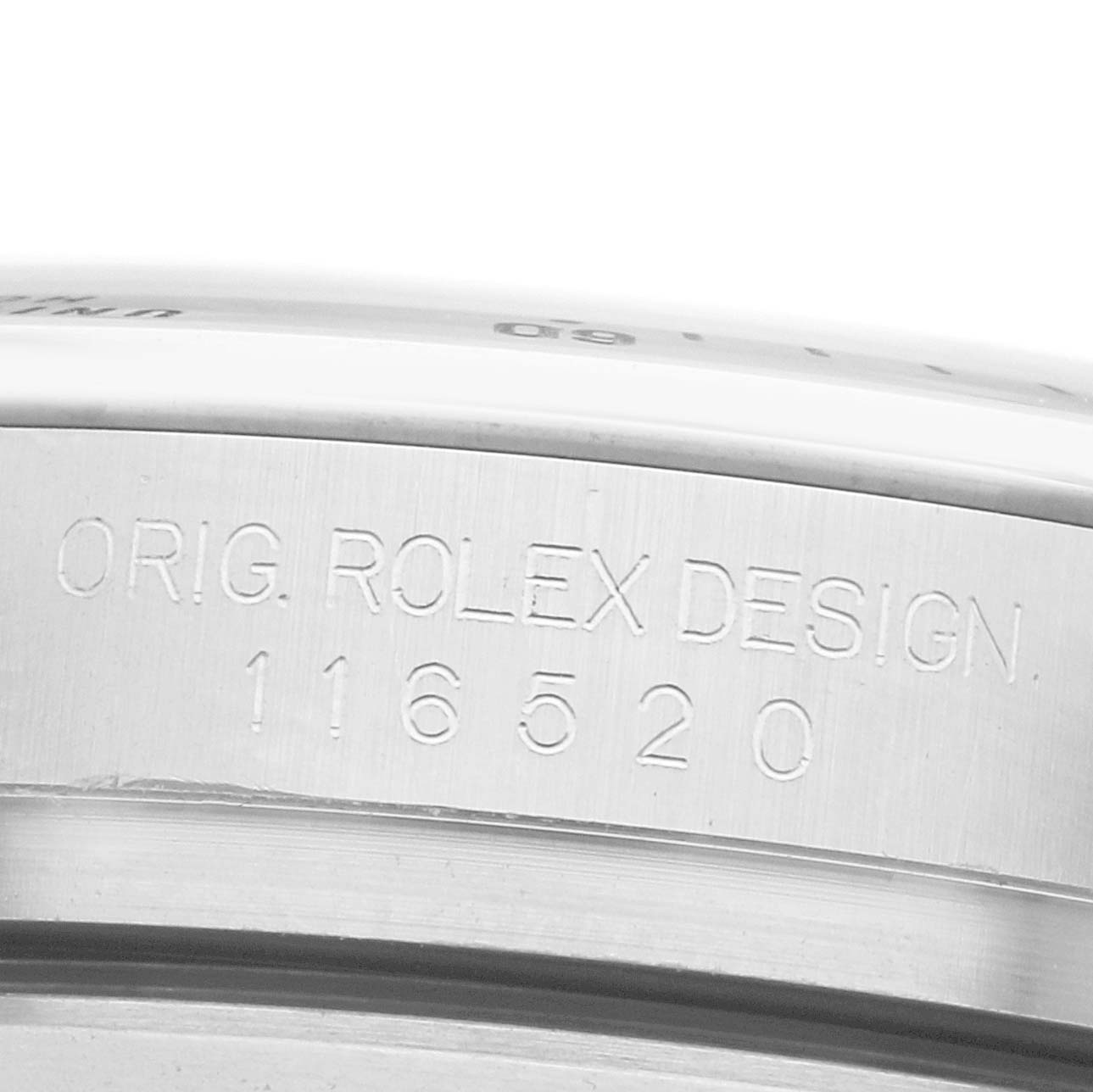 The image shows a close-up of the Rolex Daytona 116520 Men
s Stainless Steel White Dial
s side engraving, highlighting the model number "116520."