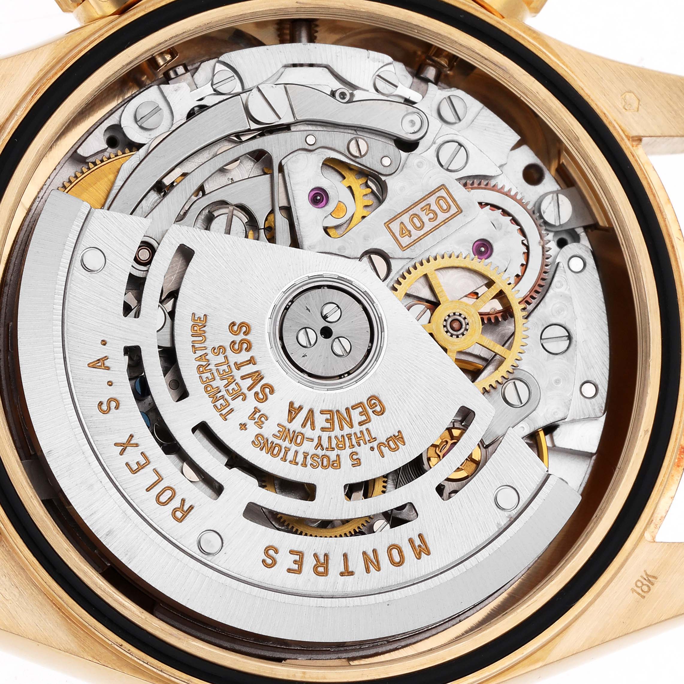 The image shows the movement mechanism of a Rolex Daytona 16528 Men
s Yellow Gold Black Dial, viewed from the back, highlighting gears and inscriptions.