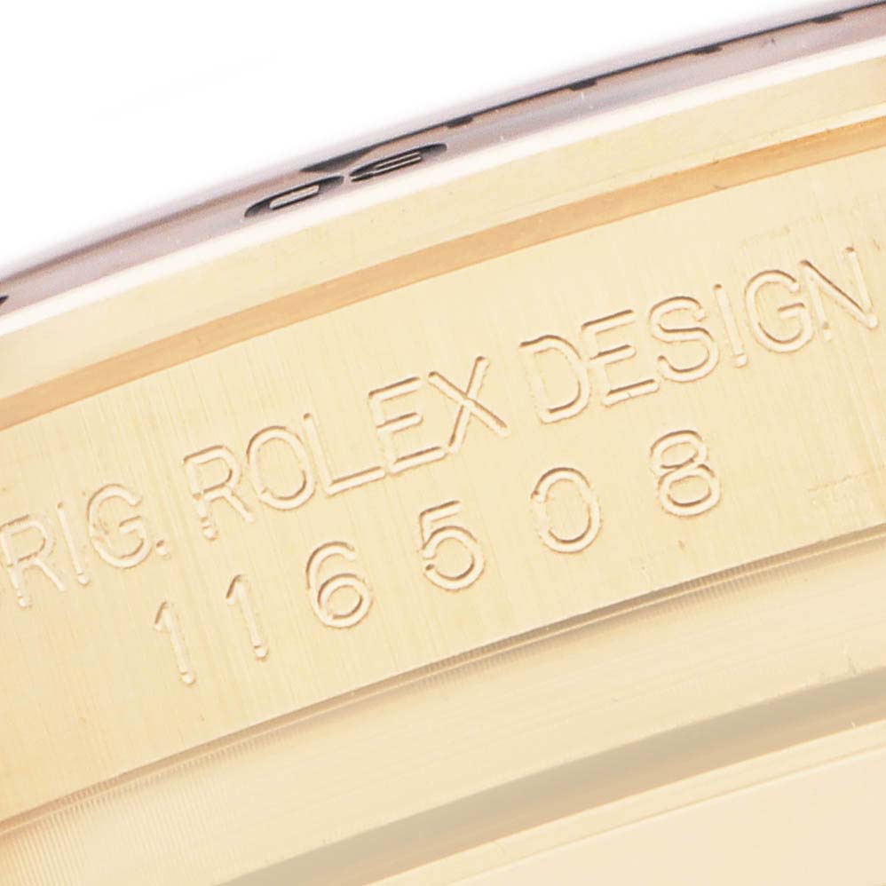 The image shows a close-up of the case side of the Rolex Daytona 116508 Men
s Yellow Gold Green Dial, highlighting the engraved model and serial numbers.