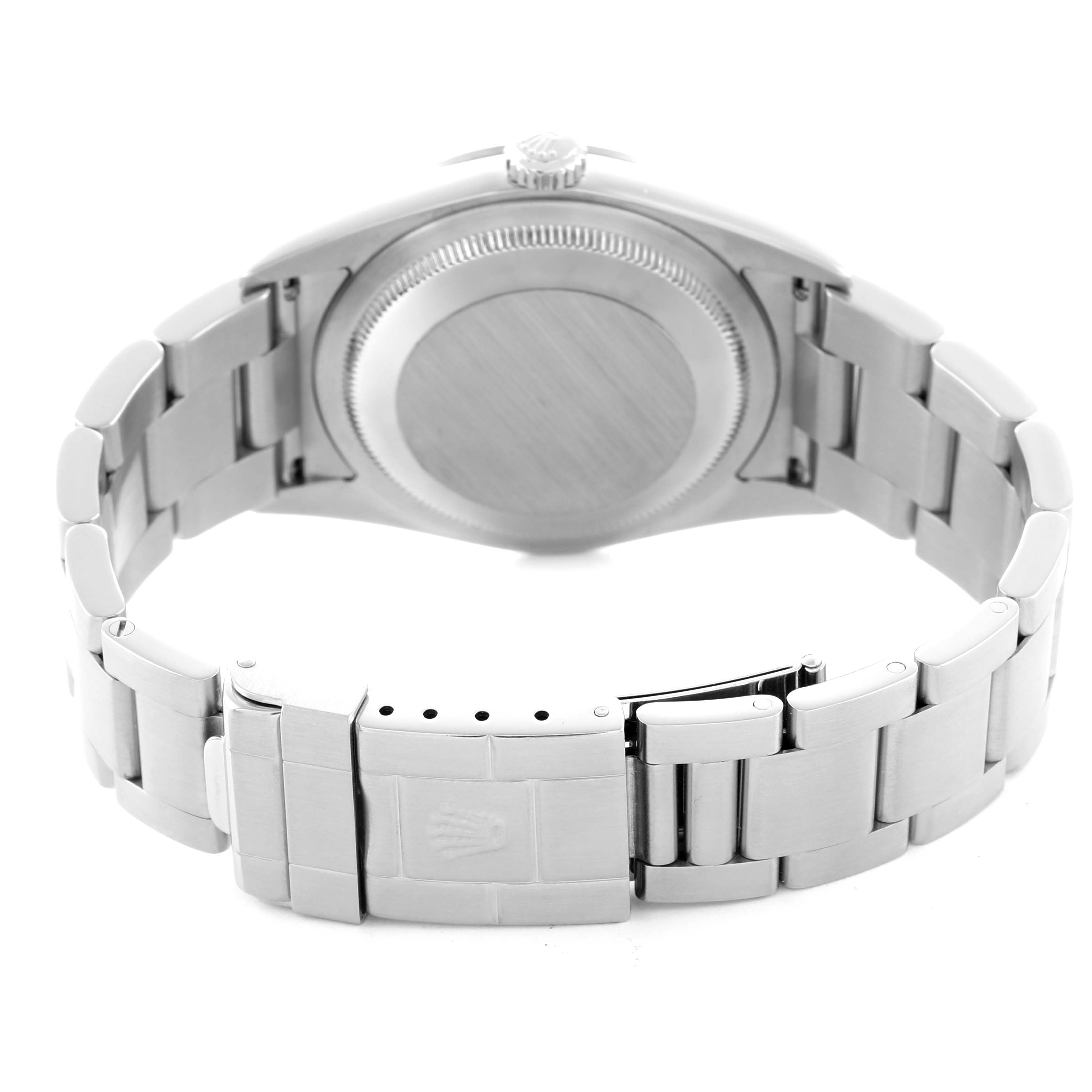 The image shows the back of a Rolex Explorer 114270 Men
s Stainless Steel Black Dial watch, highlighting the case back and metal bracelet with a clasp.