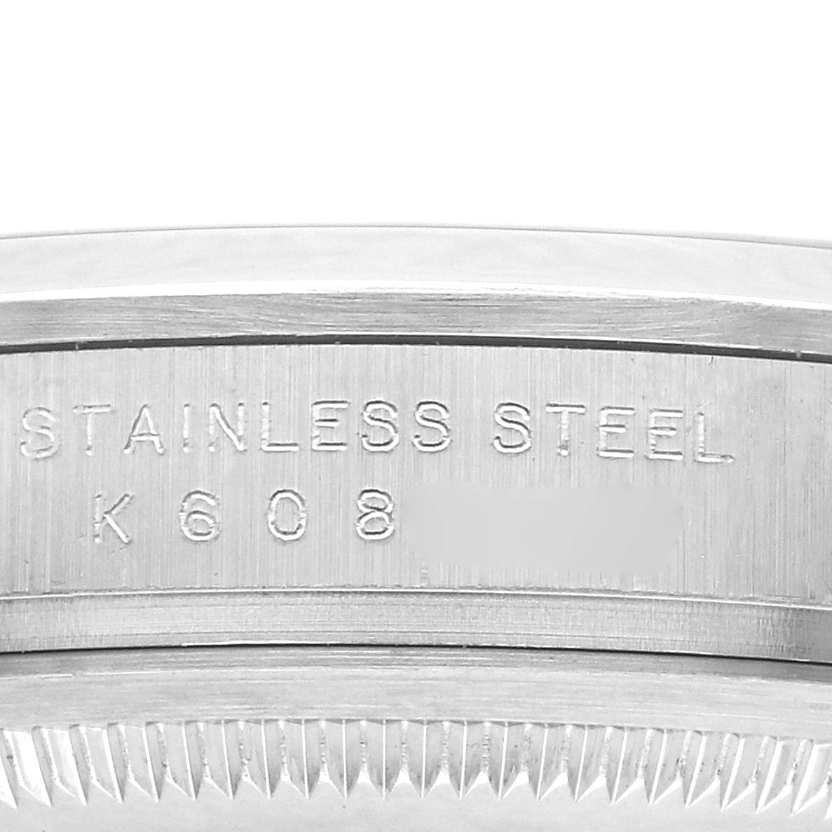 The image shows a close-up of the side of a Rolex Explorer 114270 Men
s Stainless Steel Black Dial watch, highlighting the stainless steel casing with engravings.