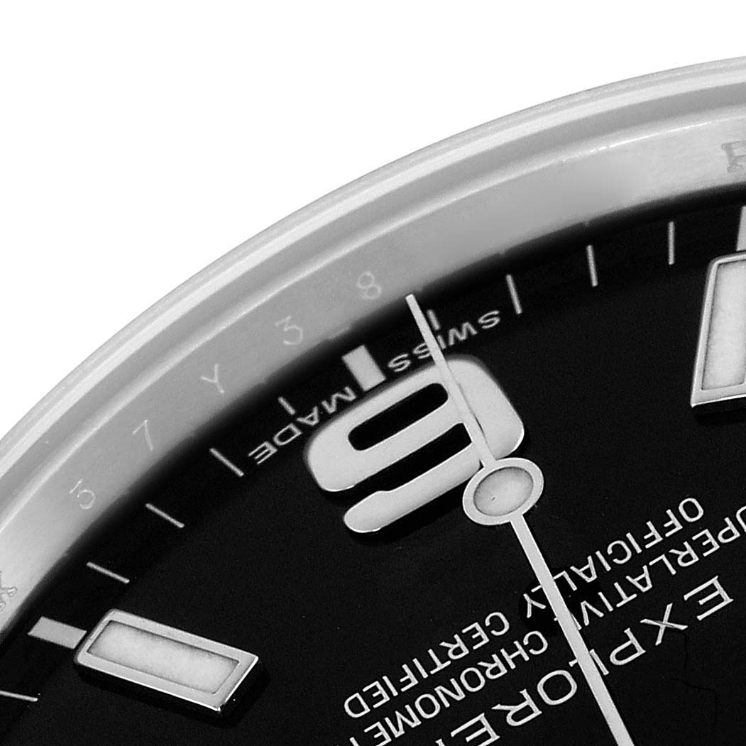 The image shows a close-up of the dial of a Rolex Explorer 214270 Men
s Stainless Steel Black Dial, highlighting the "9" marker and text.