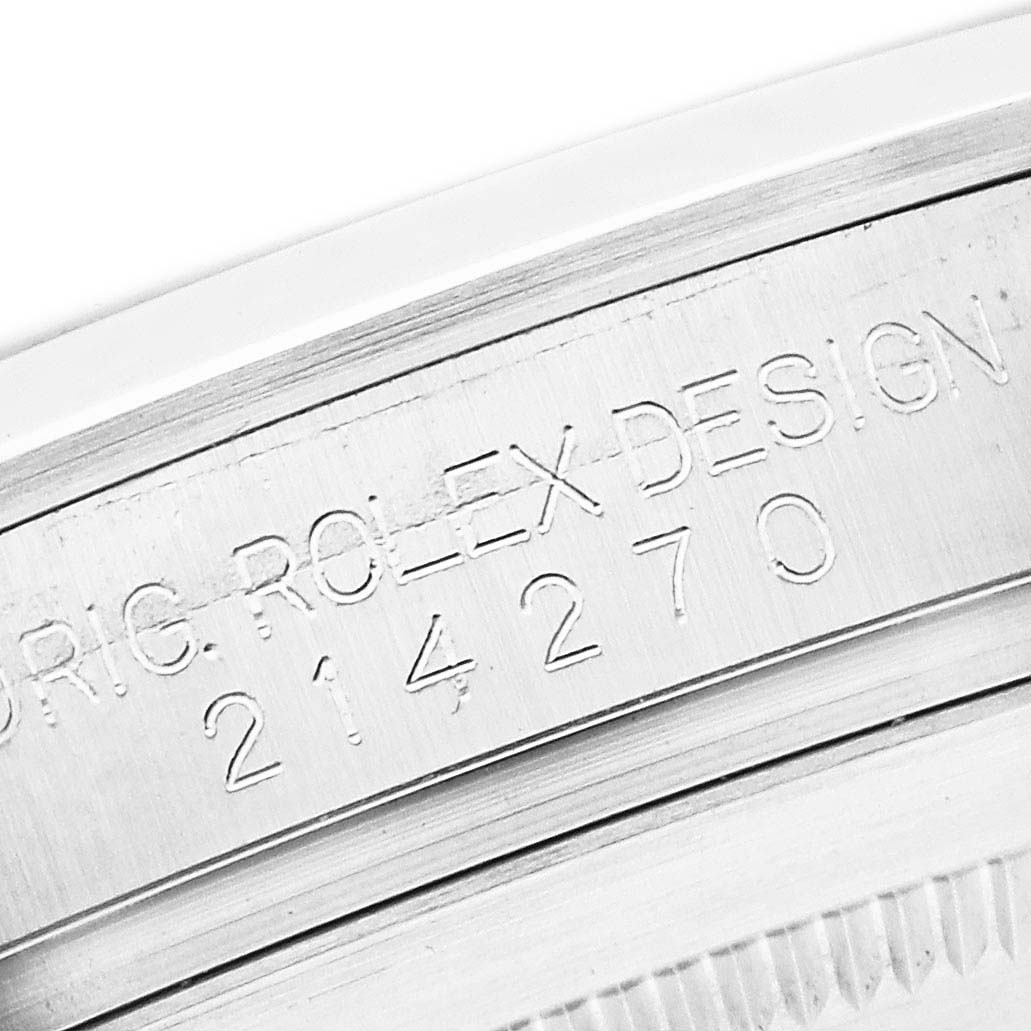 The image shows an angled close-up of the Rolex Explorer 214270 Men
s Stainless Steel Black Dial
s case engraving with model number.