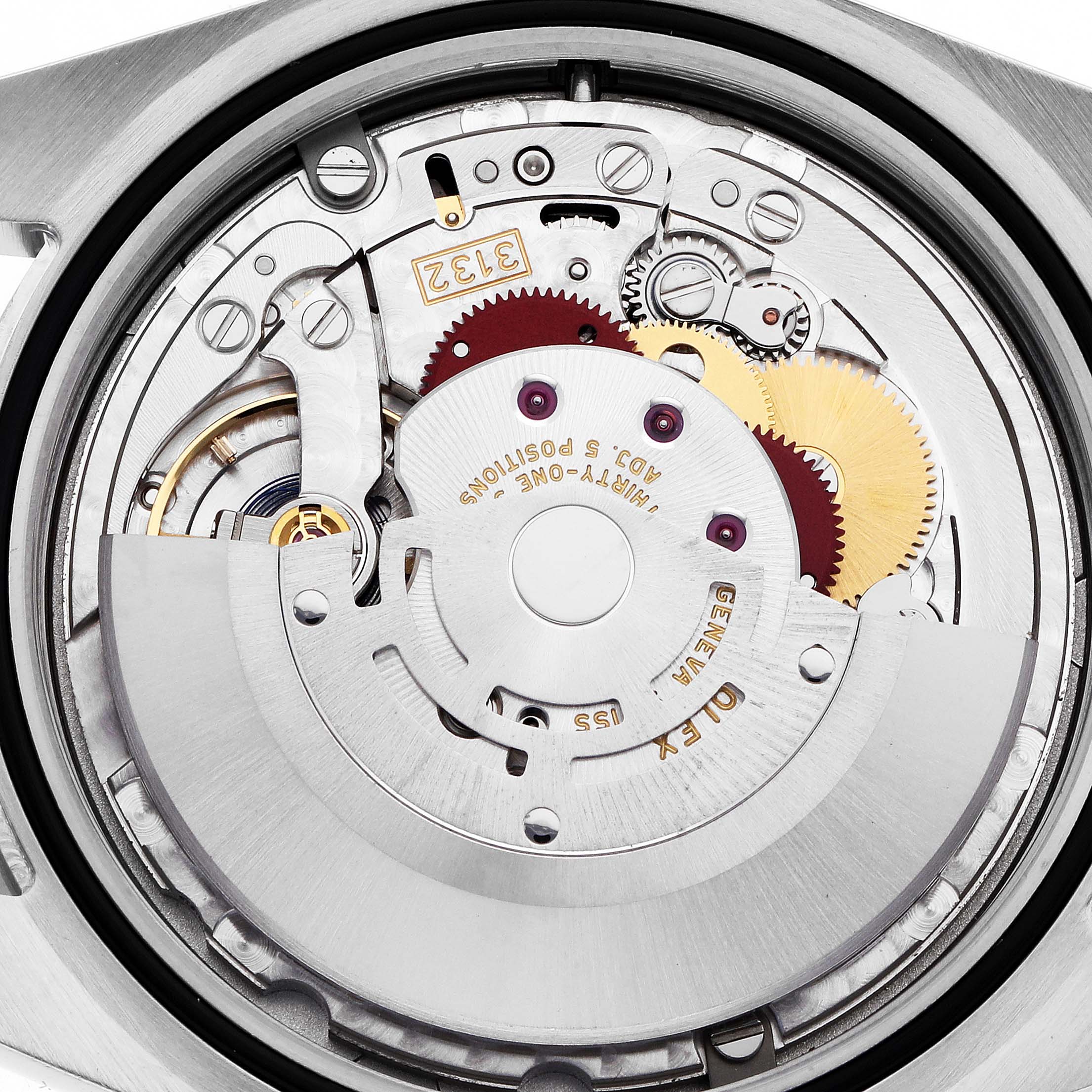 The image shows a close-up of the movement mechanism inside a Rolex Explorer 214270 Men
s Stainless Steel Black Dial watch.
