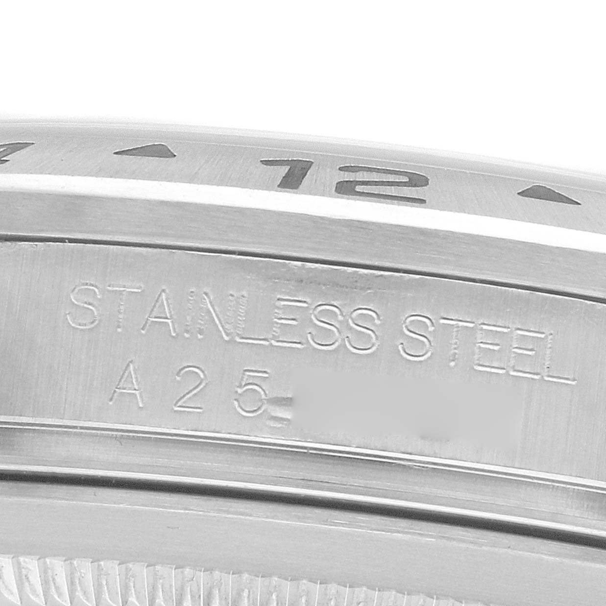 The image shows a close-up of the stainless steel bezel and outer edge of the Rolex Explorer 16570 Men
s Stainless Steel Black Dial watch case with engraved numbers.
