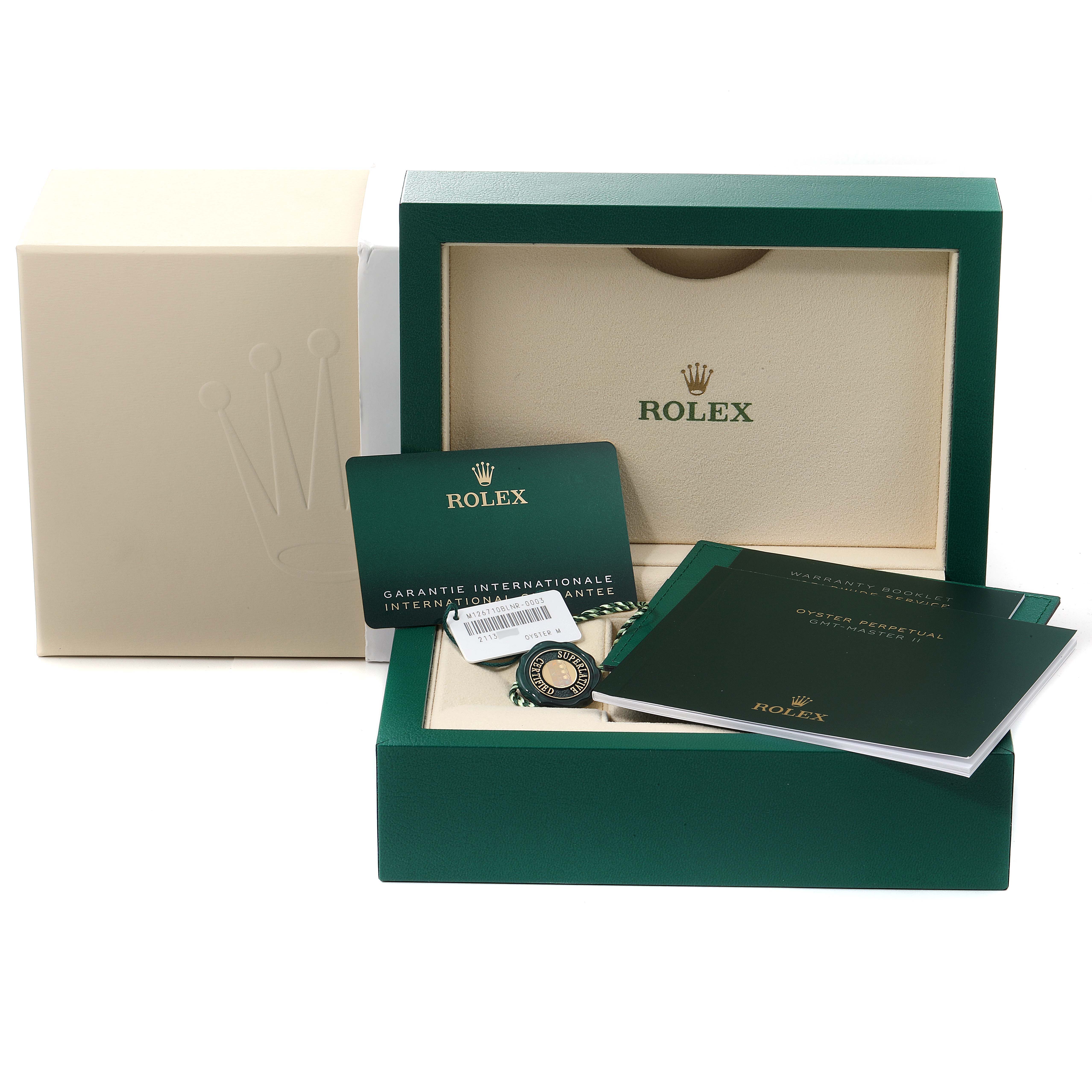 The image shows the packaging, manuals, warranty card, and certification accessories for a Rolex GMT-Master 126710 Men
s Stainless Steel Black Dial 126710 Men
s Stainless Steel Black Dial watch.