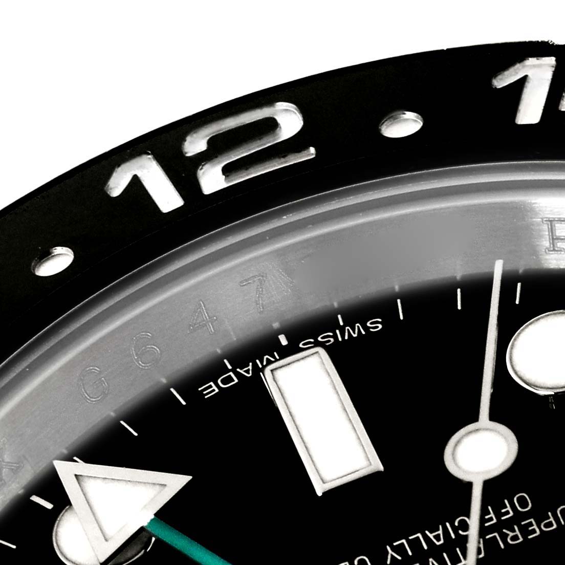 This close-up image of a Rolex GMT-Master 116710 Men
s Stainless Steel Black Dial 116710 Men
s Stainless Steel Black Dial watch shows the 12 o
clock marker, part of the bezel, and the dial with the hands.