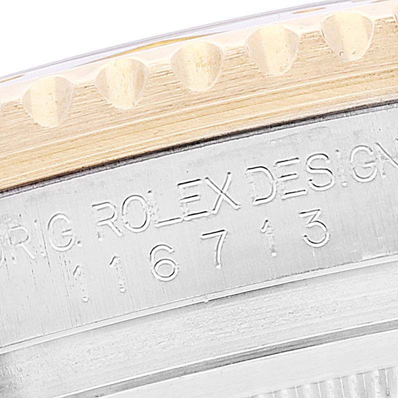 Close-up view of the side of a Rolex GMT-Master 116713 Men's Steel and Gold (two tone) Black Dial 116713 Men's Steel and Gold (two tone) Black Dial bezel, showcasing the model number engraving.