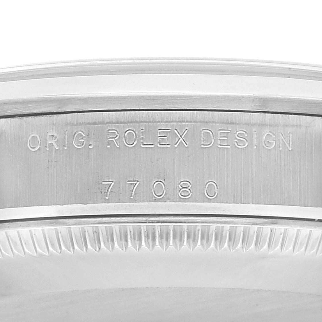 The image shows the side of the Rolex Mid-Size 77080 Women
s Stainless Steel Silver Dial 77080 Women
s Stainless Steel Silver Dial watch case with the model number 77080 and "ORIG. ROLEX DESIGN" engraving visible.