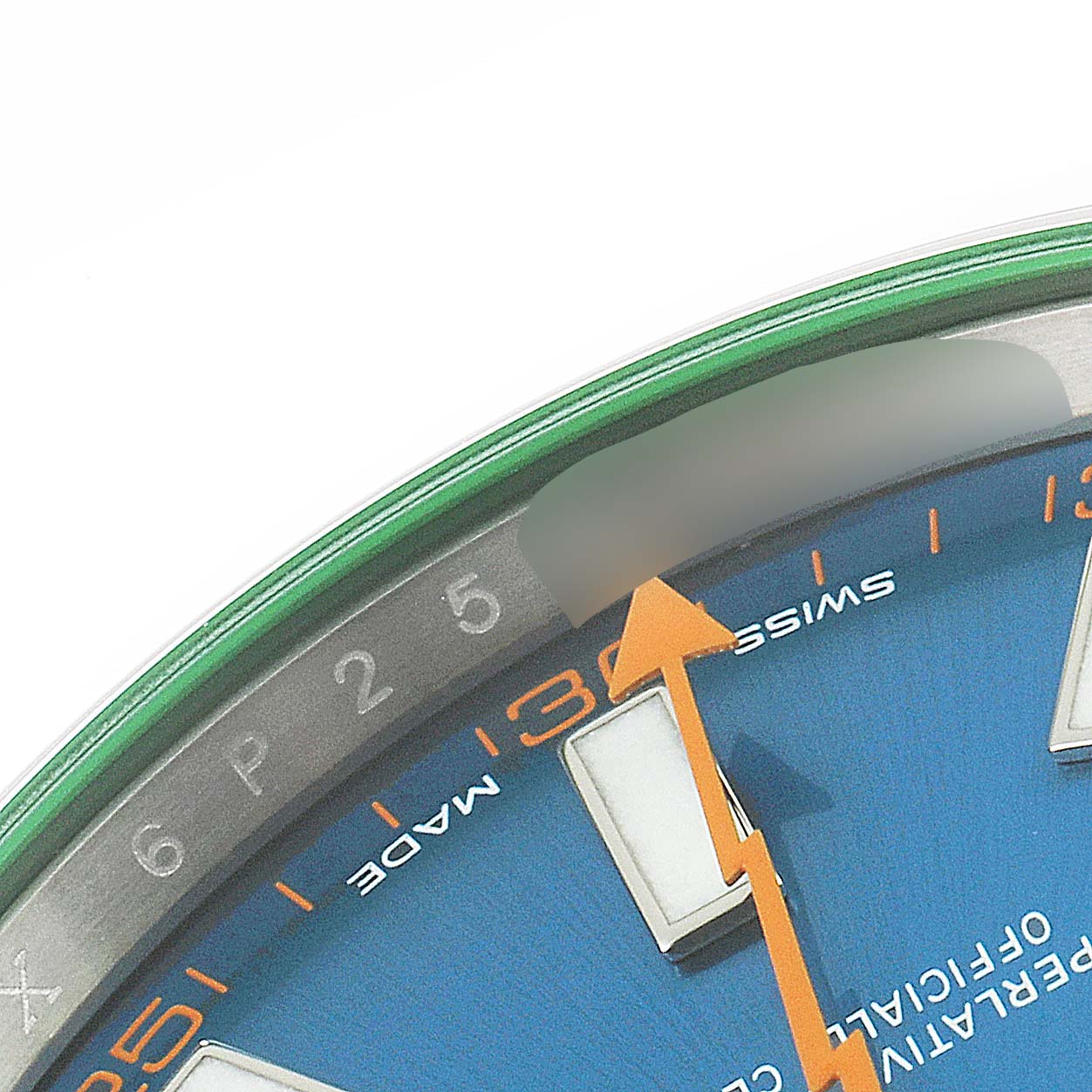 This close-up of a Rolex Milgauss 116400GV Men's Stainless Steel Blue Dial 116400GV Men's Stainless Steel Blue Dial watch shows part of the green-edged crystal, blue dial, and orange hand pointing at the Swiss-Made marking.