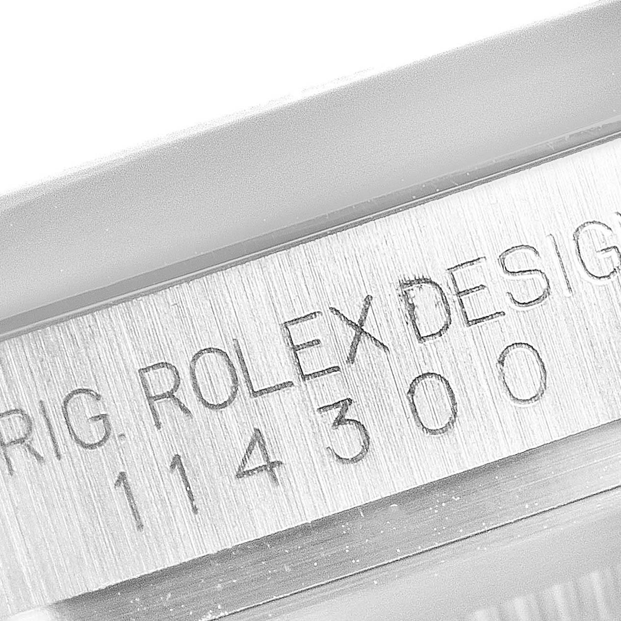 This close-up angle shows the engraved model number "114300" on the case of a Rolex Oyster Perpetual 114300 Men
s Stainless Steel Silver Dial 114300 Men
s Stainless Steel Silver Dial watch.