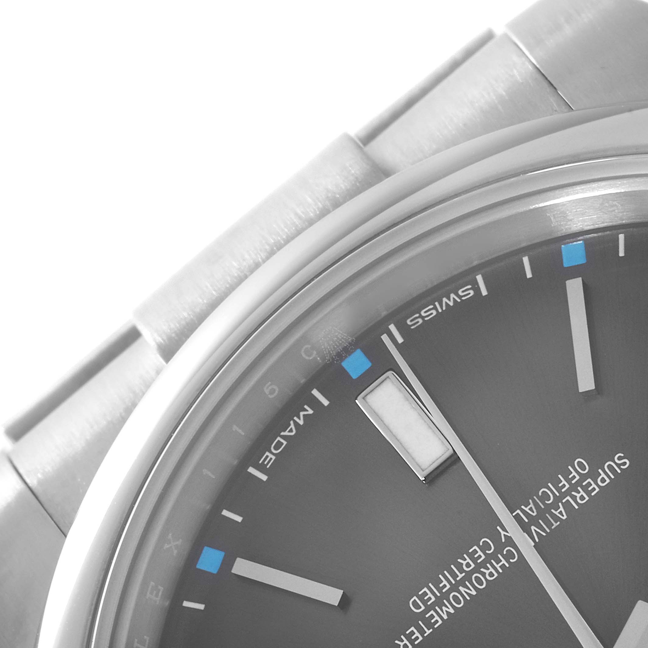 This image shows a close-up of the dial and part of the strap of a Rolex Oyster Perpetual 114300 Men's Stainless Steel Grey Dial 114300 Men's Stainless Steel Grey Dial watch.