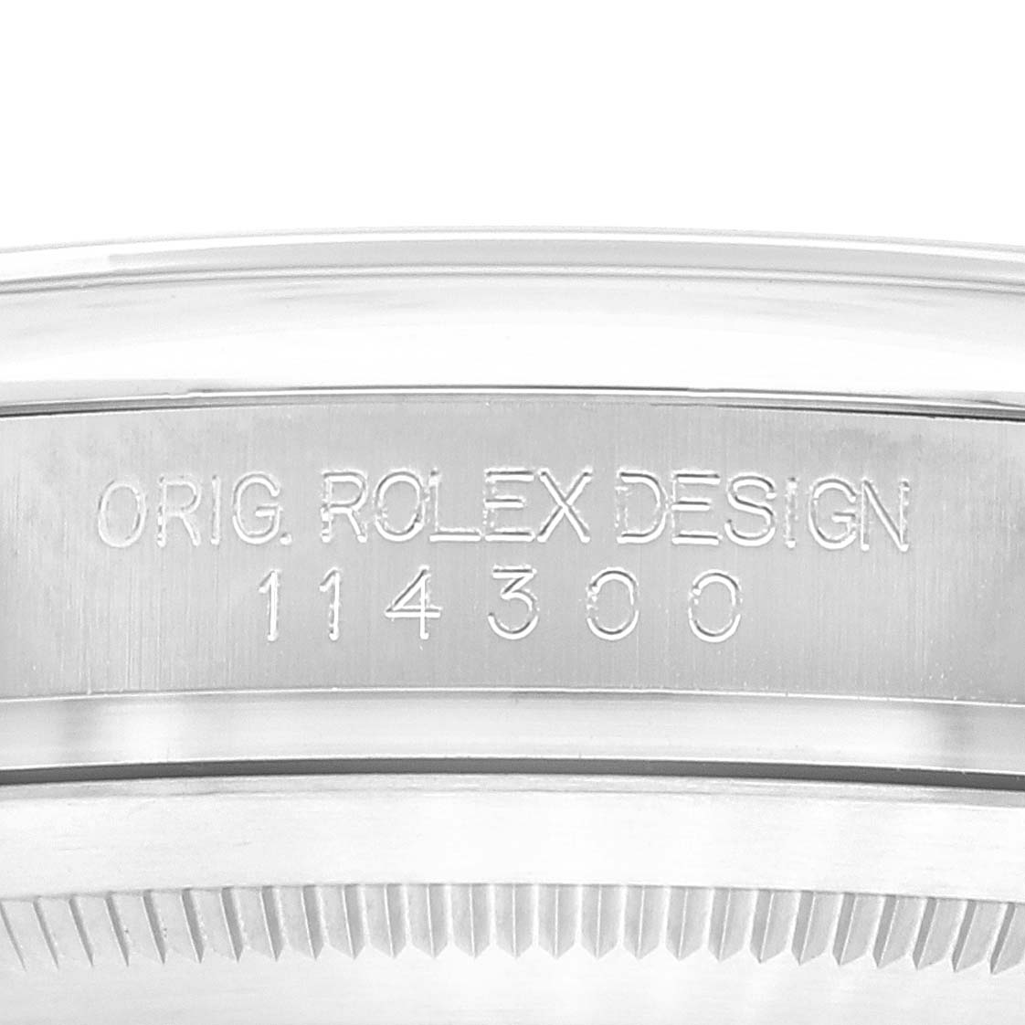 This image shows a close-up of the engraved case back and inner rim of a Rolex Oyster Perpetual 114300 Men's Stainless Steel Grey Dial 114300 Men's Stainless Steel Grey Dial model.