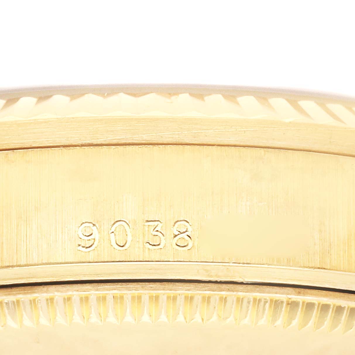 This image shows the side of a Rolex Mid-Size 68278 Women's Yellow Gold White Dial 68278 Women's Yellow Gold White Dial model watch case with the serial number 9038 engraved.