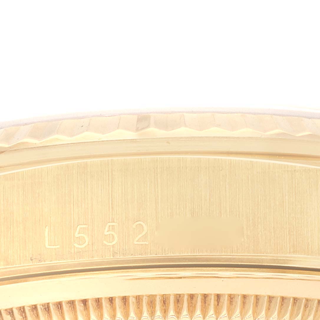 This image shows a close-up of the side view of a Rolex President 18238 Men's Yellow Gold Champagne Dial 18238 Men's Yellow Gold Champagne Dial model watch case with visible engravings.