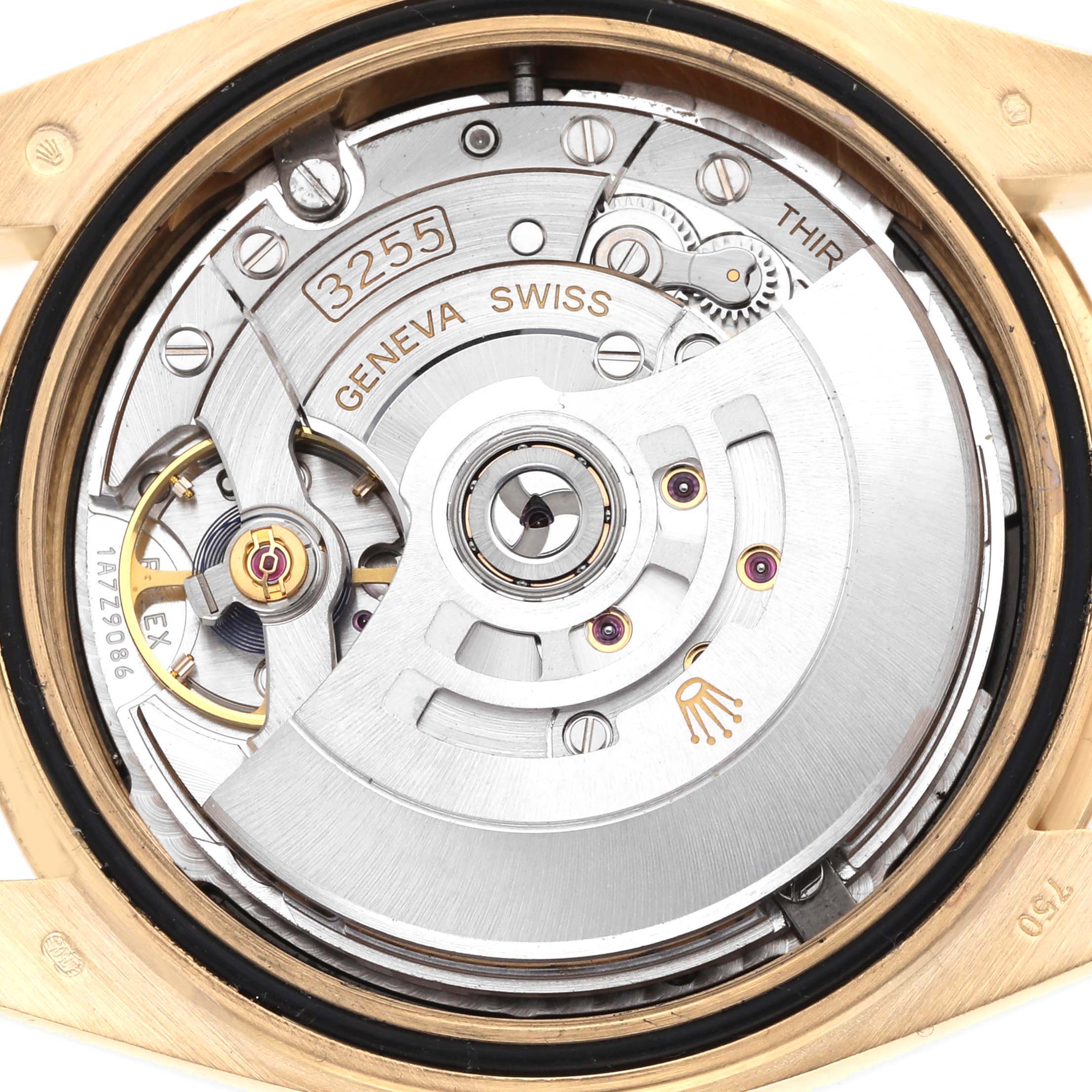 The image shows the movement of a Rolex President 228238 Men
s Yellow Gold Black Dial model from a rear angle, highlighting its Geneva markings and intricate mechanics.