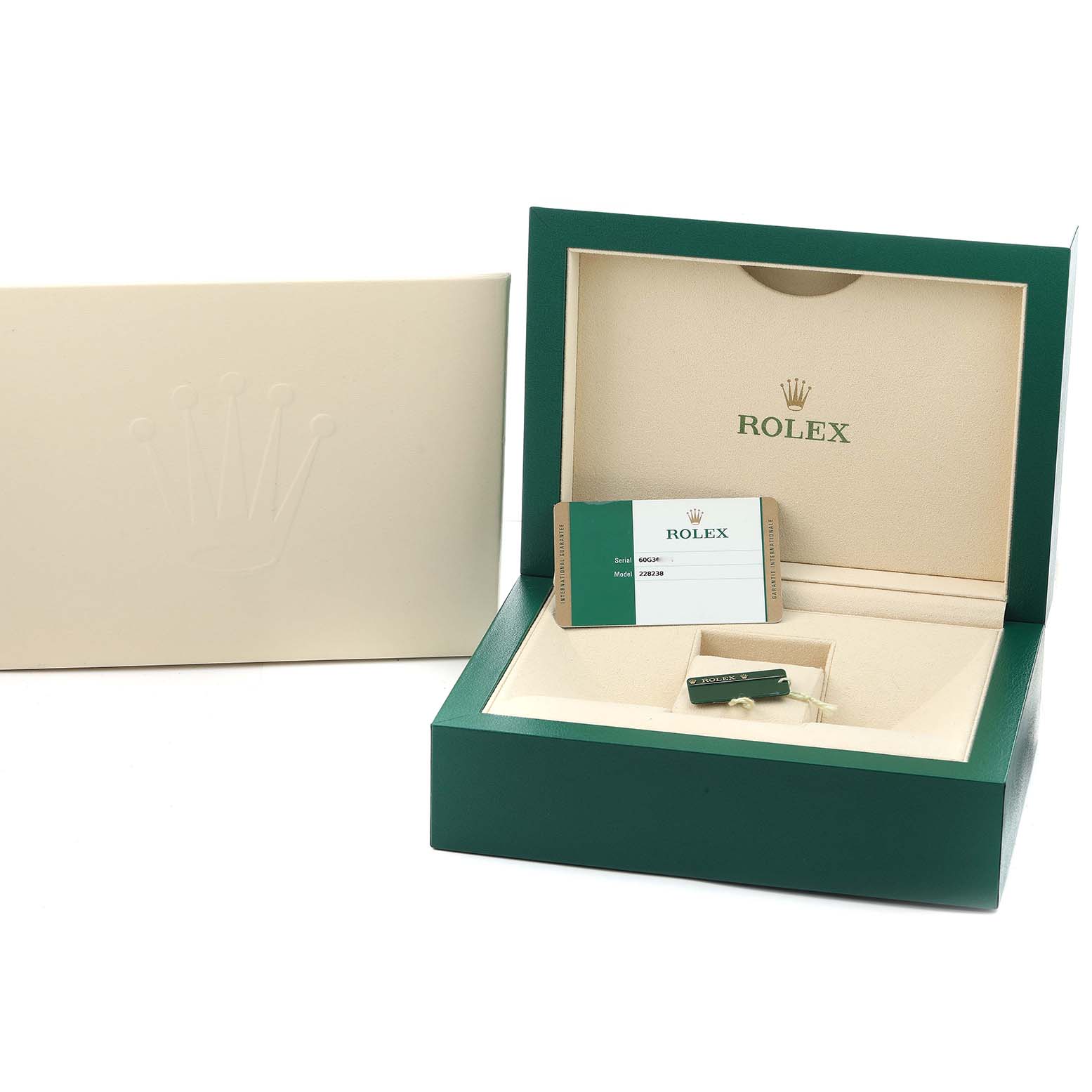 The image shows the open box for a Rolex President 228238 Men
s Yellow Gold Black Dial model, displaying the inside with tags and a card.