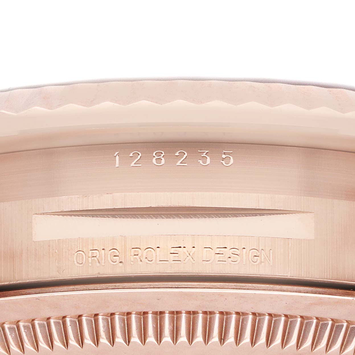 The image shows a close-up of the side of the Rolex President 128235 Men
s Rose Gold Mother of Pearl Dial model, highlighting the engraved design and serial number.