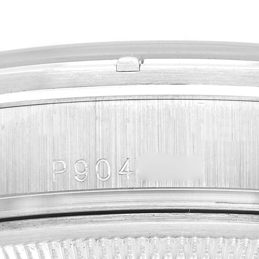 This image shows a close-up of the side of a Rolex President 118366 Men
s Platinum Silver Dial model case, highlighting its serial number and grooves.