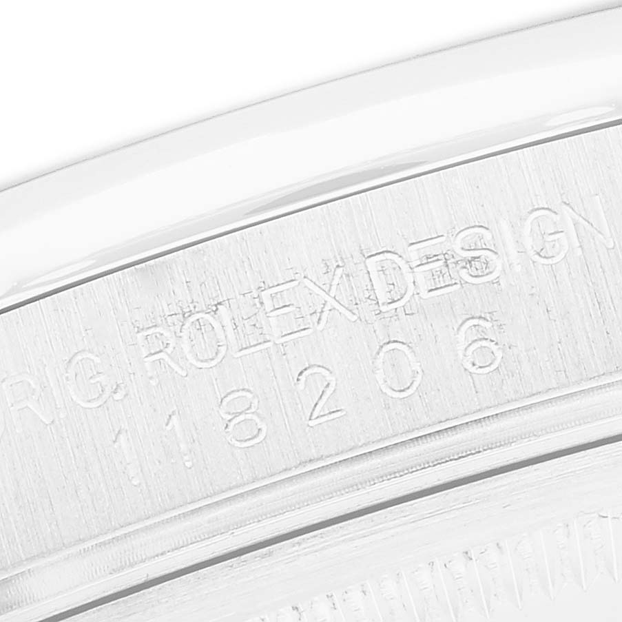 The image shows an engraved side view of a Rolex President 118206 Men
s Platinum Blue Dial watch, focusing on the model number and branding.