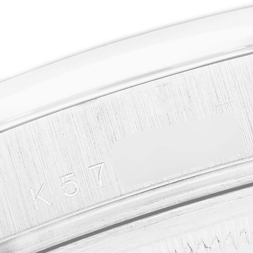The image shows a close-up of the bezel and serial engraving on the Rolex President 118206 Men
s Platinum Blue Dial watch.