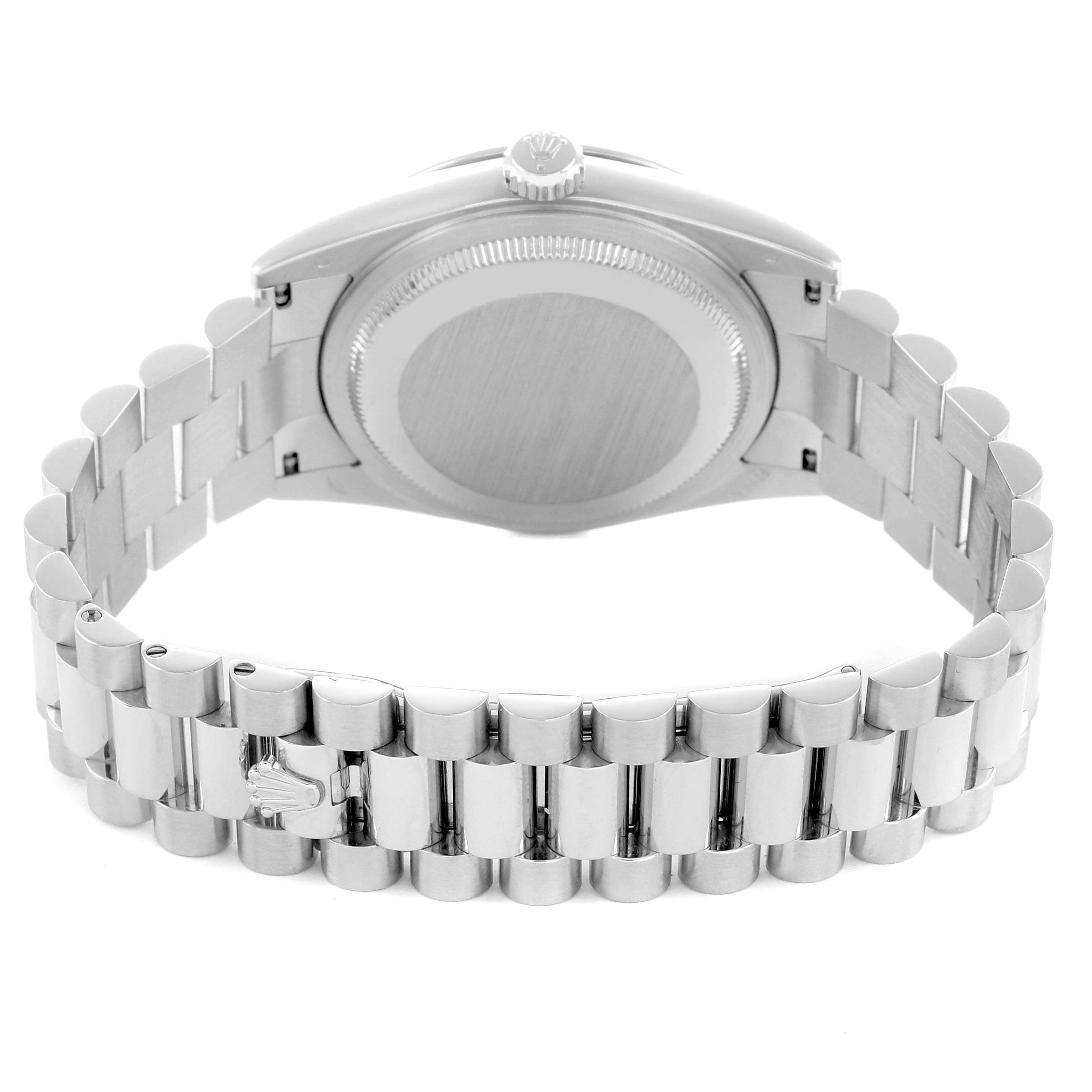 The Rolex President 118206 Men
s Platinum Blue Dial model is shown from the back, highlighting the case back, crown, and bracelet clasp.