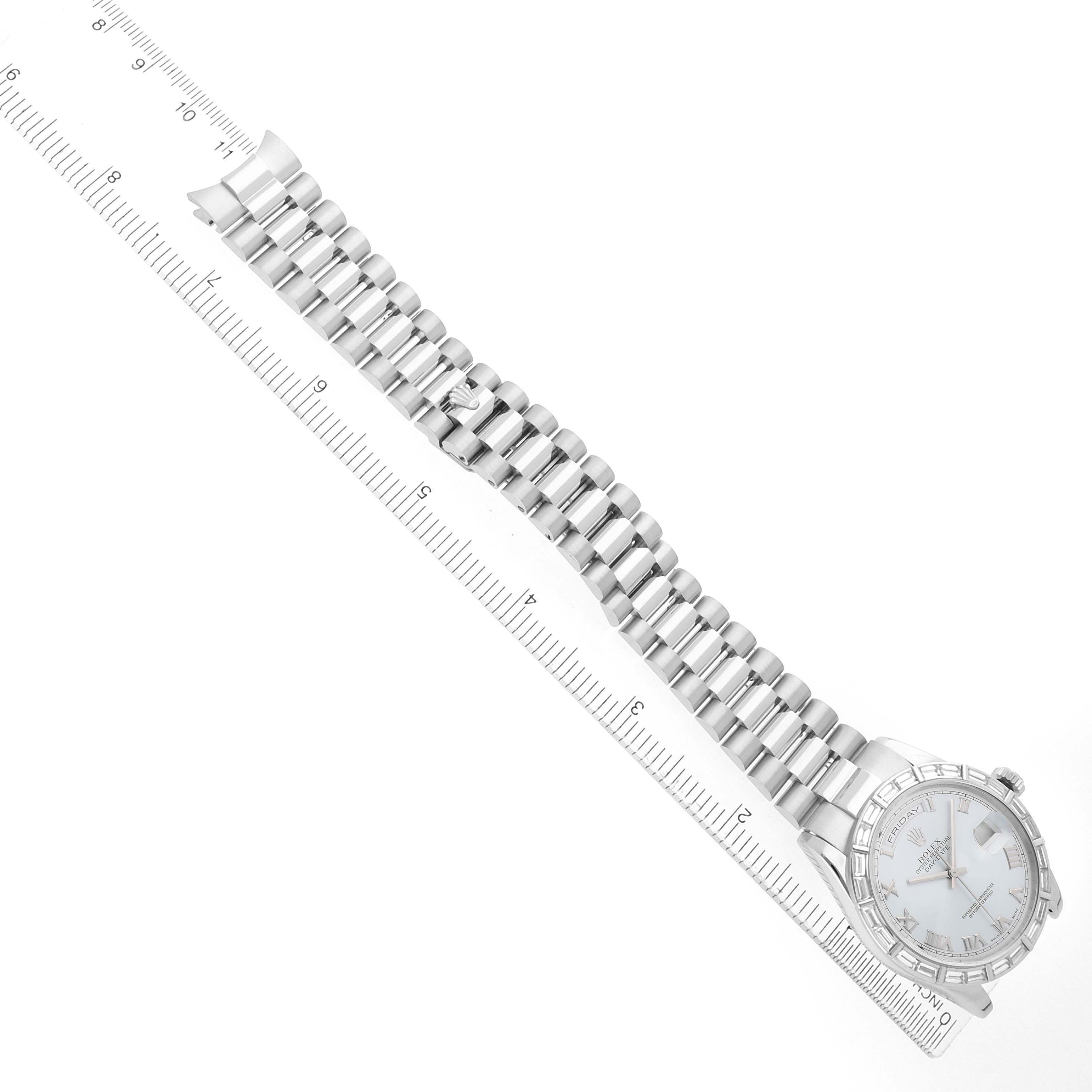 The Rolex President 118366 Men's Platinum Blue Dial model is shown from a top-down angle, displaying the watch face and full bracelet beside a ruler.