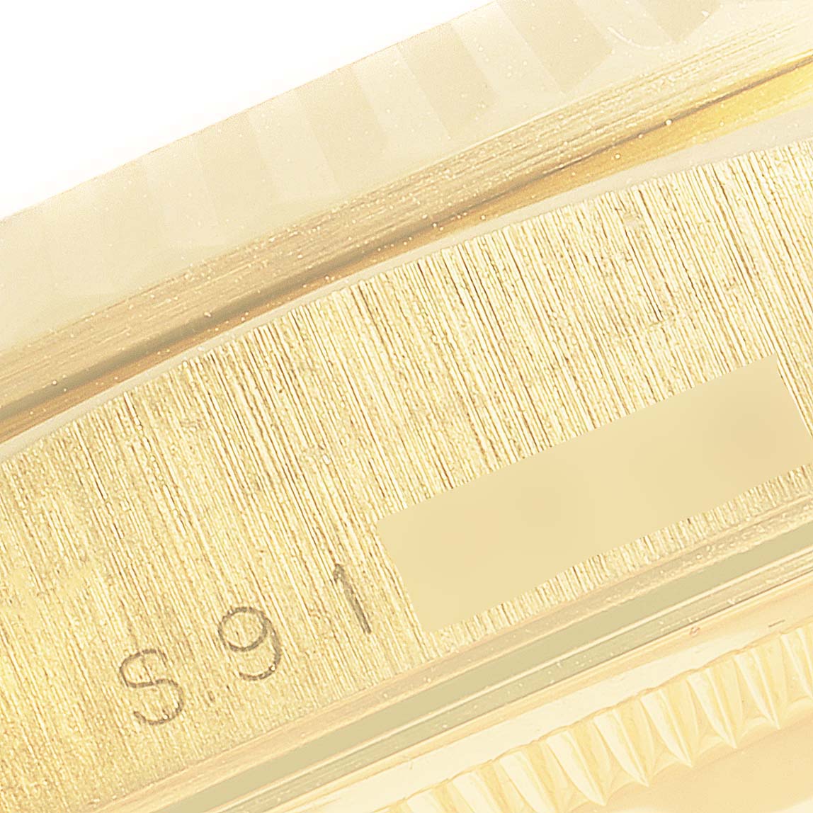 This is a close-up image of the engravings on the side of the case of a Rolex President 18238 Men
s Yellow Gold Champagne Dial 18238 Men
s Yellow Gold Champagne Dial model watch.