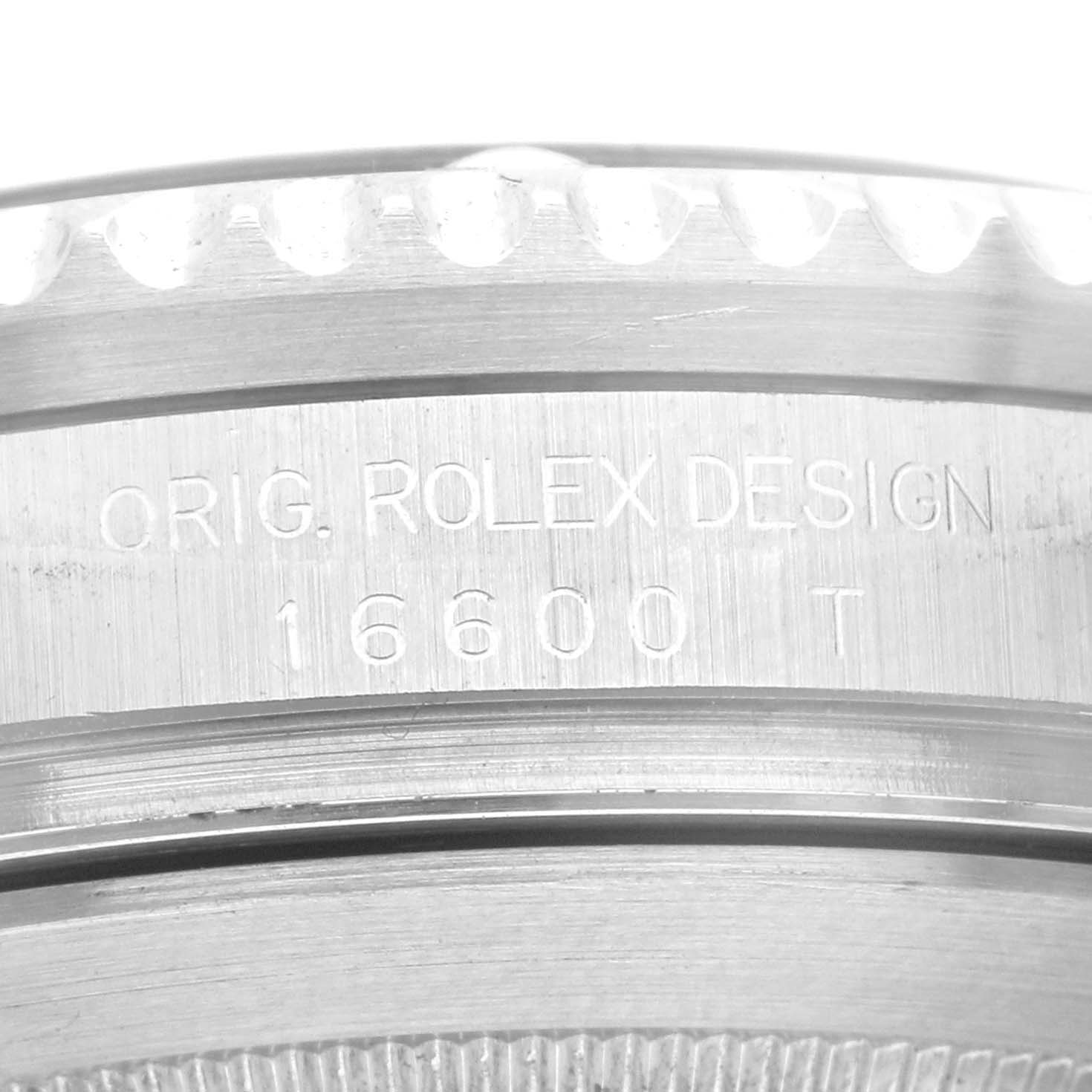 This image shows a close-up of the engraved serial number "16600 T" on the side of a Rolex Sea-Dweller 16600 Men
s Stainless Steel Black Dial 16600 Men
s Stainless Steel Black Dial watch.