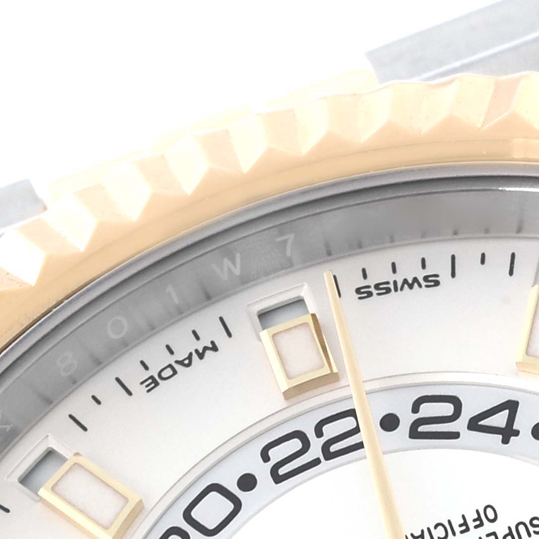 This close-up angle of the Rolex Sky-Dweller 326933 Men's Steel and Gold (two tone) White Dial 326933 Men's Steel and Gold (two tone) White Dial watch shows part of its face, including the bezel, hour markers, and partially the 24-hour subdial.