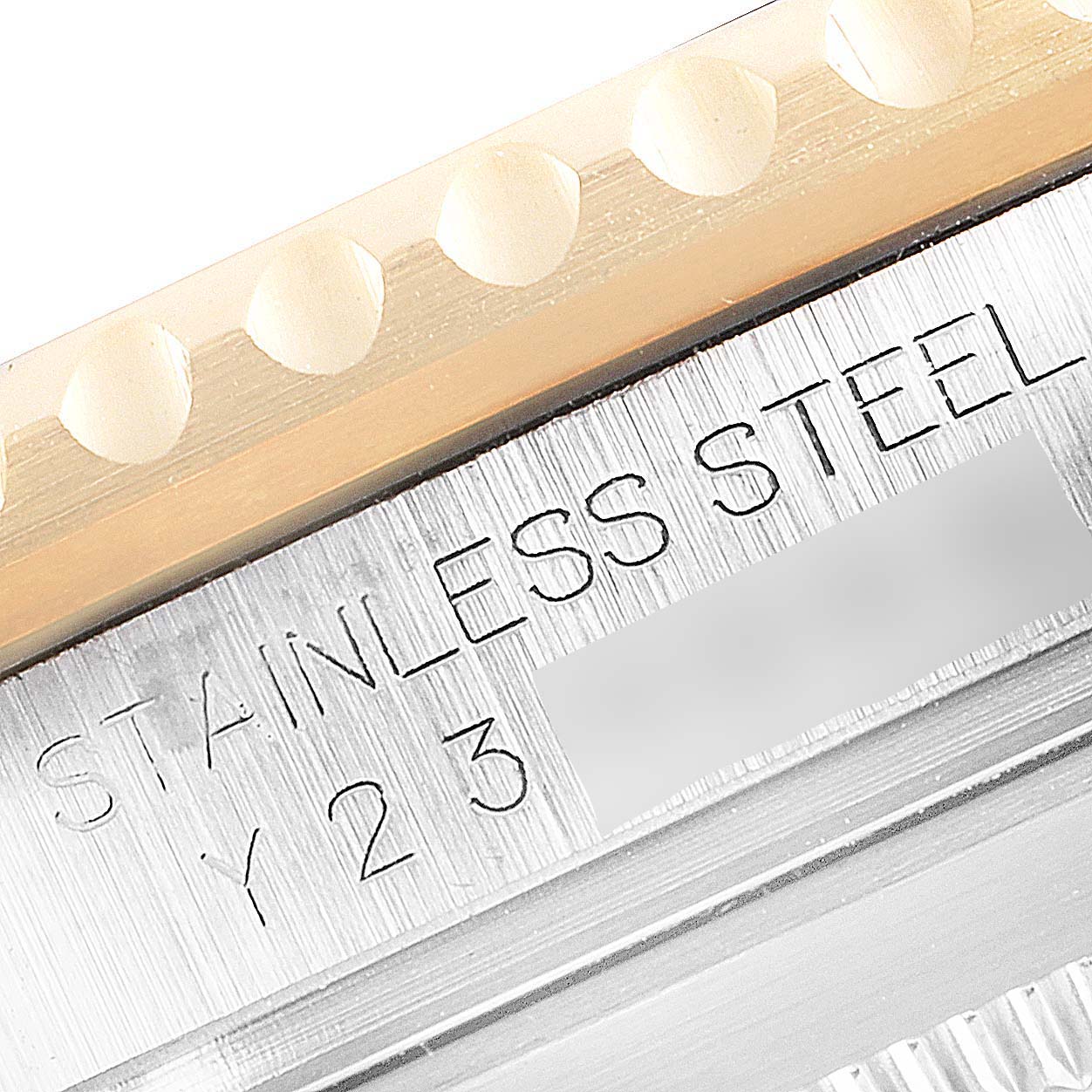 This image shows a close-up of the engraved stainless steel case and bezel of a Rolex Submariner 16613 Men's Steel and Gold (two tone) Blue Dial 16613 Men's Steel and Gold (two tone) Blue Dial watch.