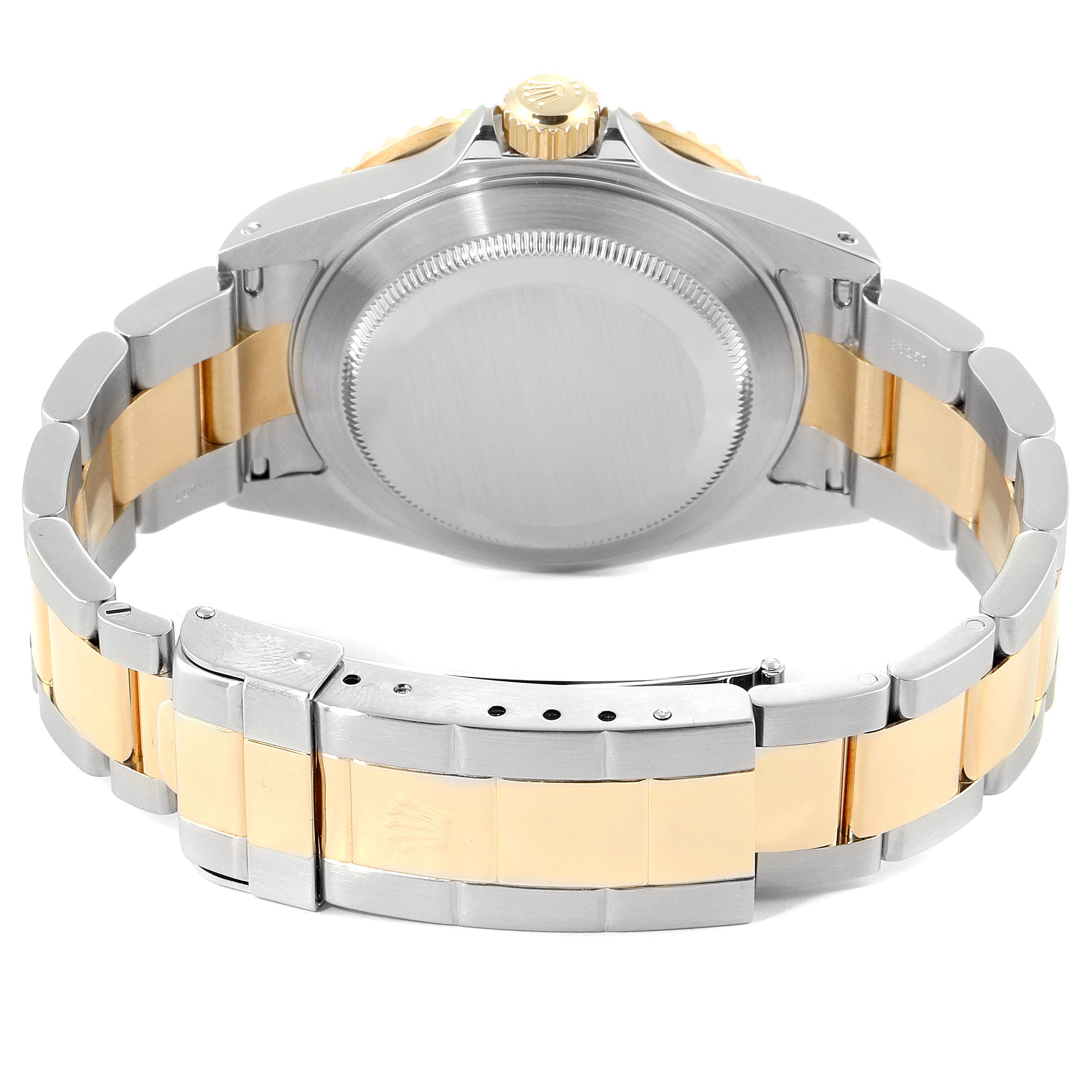 The image shows the back view of a Rolex Submariner 16613 Men's Steel and Gold (two tone) Blue Dial 16613 Men's Steel and Gold (two tone) Blue Dial watch, highlighting its case back, crown, and two-tone bracelet.