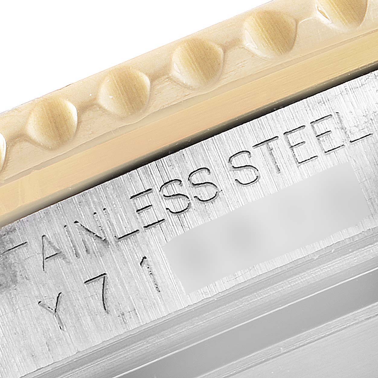 This image shows a close-up of the bezel and the engraved "STAINLESS STEEL" label on a Rolex Submariner 16613 Men's Steel and Gold (two tone) Blue Dial 16613 Men's Steel and Gold (two tone) Blue Dial watch.