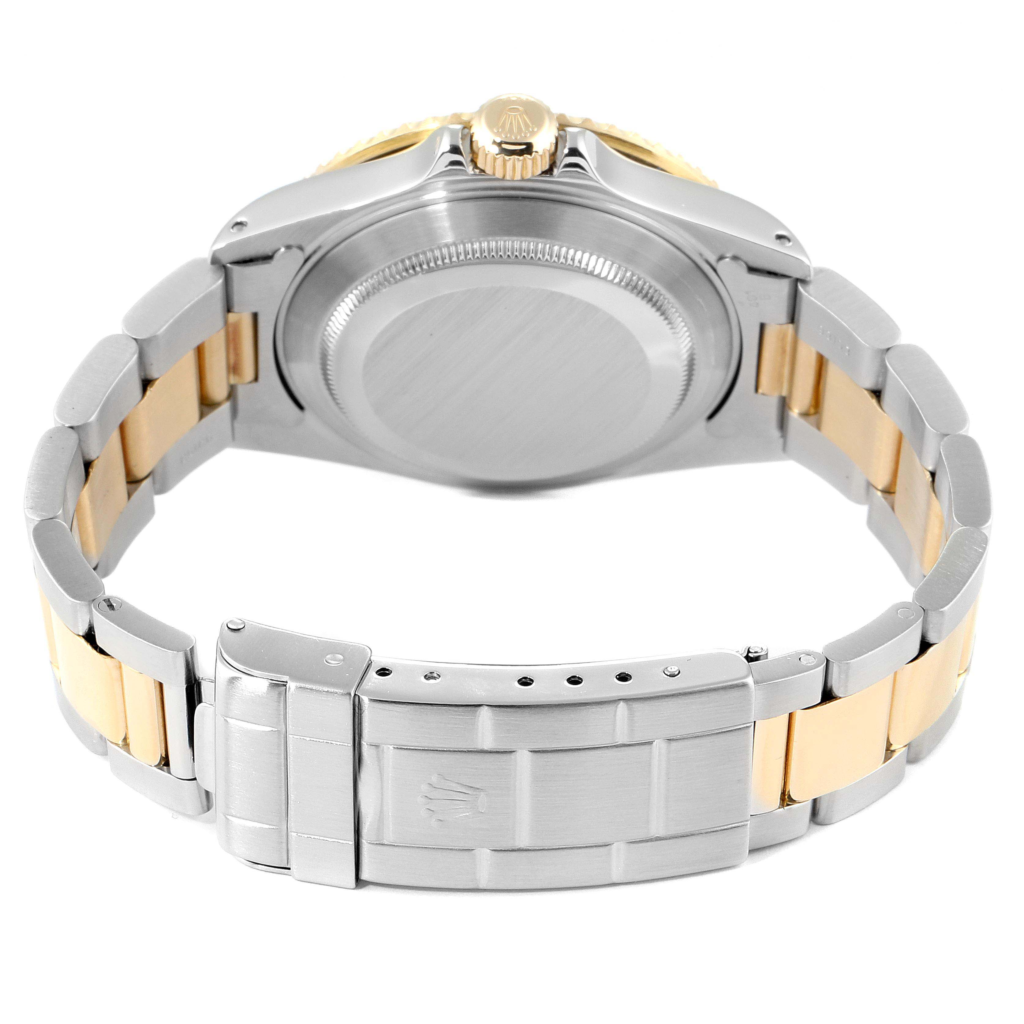 This image shows the back view of a Rolex Submariner 16613 Men's Steel and Gold (two tone) Black Dial 16613 Men's Steel and Gold (two tone) Black Dial watch, focusing on its case back, crown, and bracelet clasp.