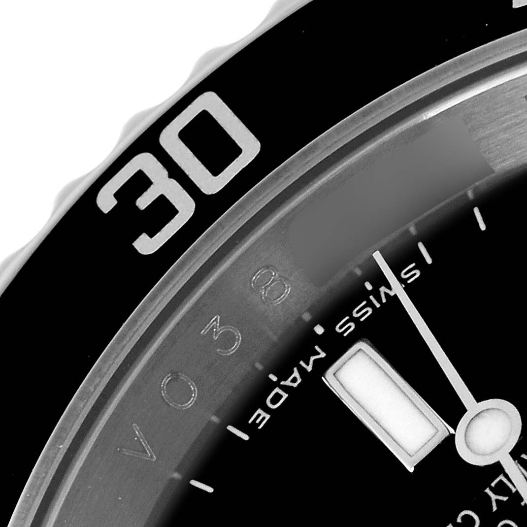 This close-up image of a Rolex Submariner 16610 Men
s Stainless Steel Black Dial 16610 Men
s Stainless Steel Black Dial watch shows the bezel with the "30" mark and part of the dial featuring the "Swiss Made" text.