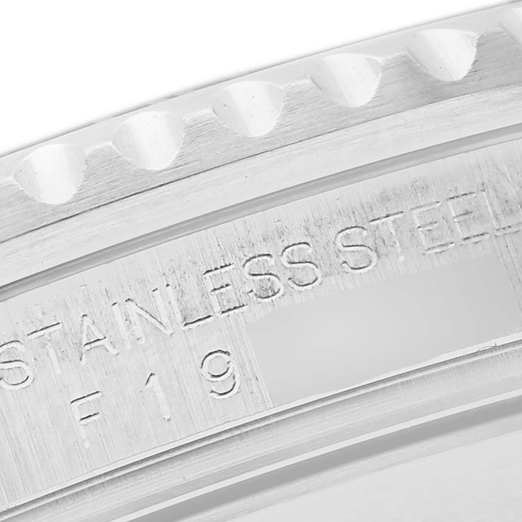 This close-up image shows the engraving on the stainless steel bezel of a Rolex Submariner 16610 Men's Stainless Steel Black Dial 16610 Men's Stainless Steel Black Dial watch.