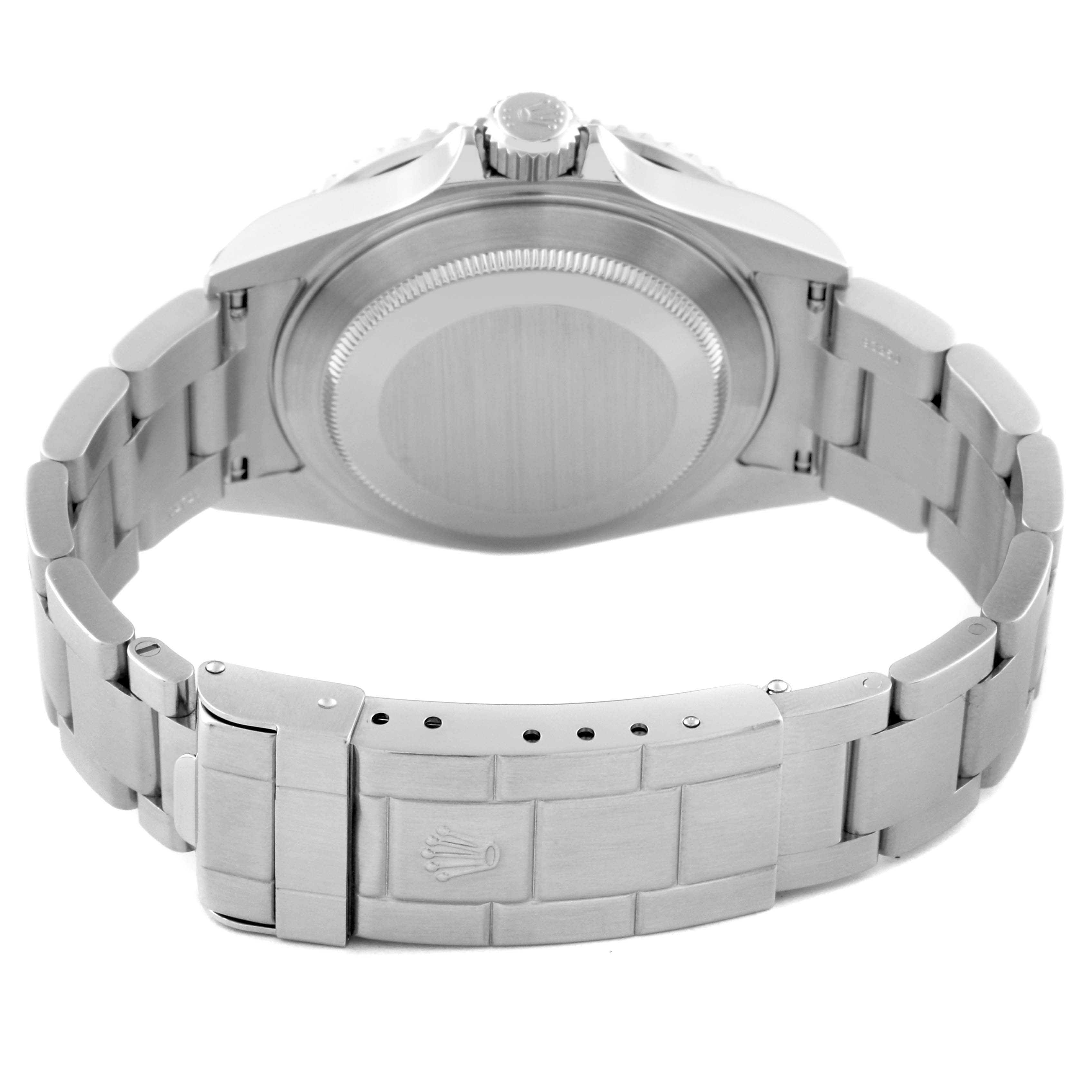 The image shows the back view of the Submariner model by Rolex, highlighting the bracelet, clasp, and case back.
