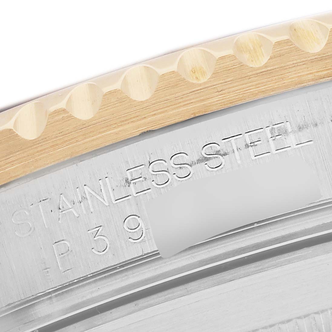 The image shows a close-up of the bezel and engraved edge of a Rolex Submariner 16613 Men
s Steel and Gold (two tone) Blue Dial watch, highlighting the stainless steel material.