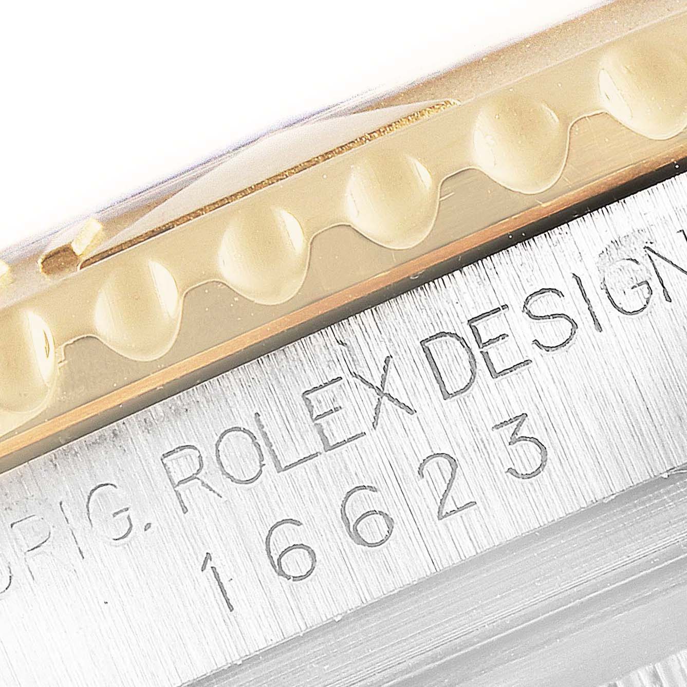 This close-up image shows the engraved case side and the gold bezel of the Rolex Yacht-Master 16623 Men
s Steel and Gold (two tone) Champagne Dial 16623 Men
s Steel and Gold (two tone) Champagne Dial watch.