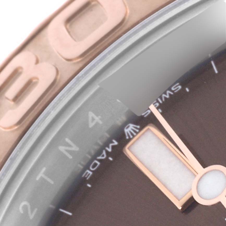 Close-up of the dial and bezel of a Rolex Yacht-Master 126621 Men's Steel and Gold (two tone) Brown Dial 126621 Men's Steel and Gold (two tone) Brown Dial watch, showing part of the hour hand and numbers on the bezel.