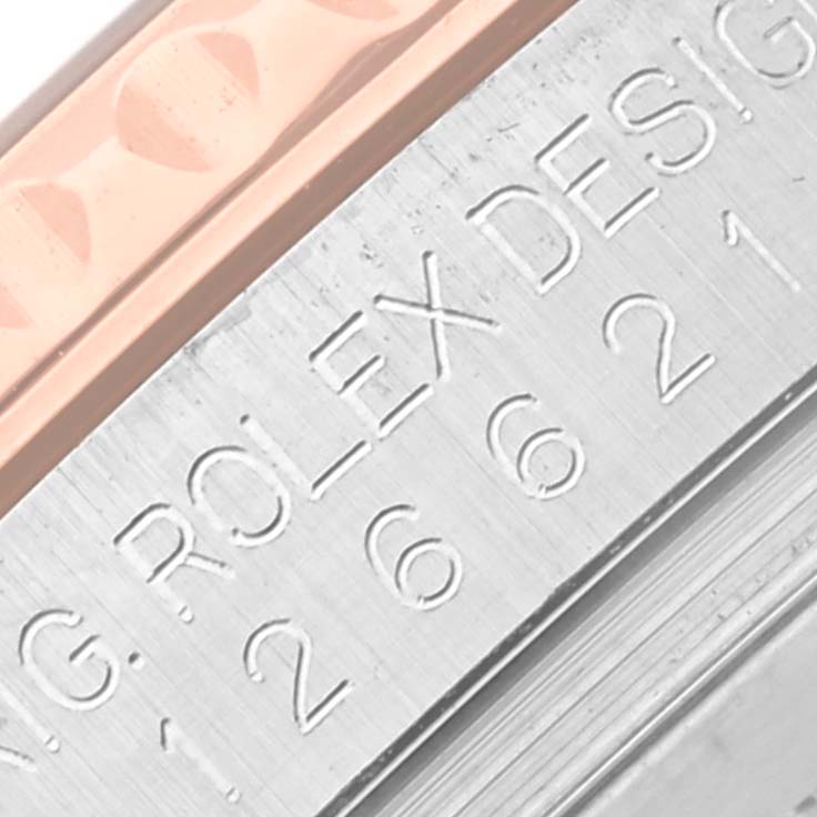 This image shows a close-up of the engraved edge and bezel of a Rolex Yacht-Master 126621 Men's Steel and Gold (two tone) Brown Dial 126621 Men's Steel and Gold (two tone) Brown Dial watch.