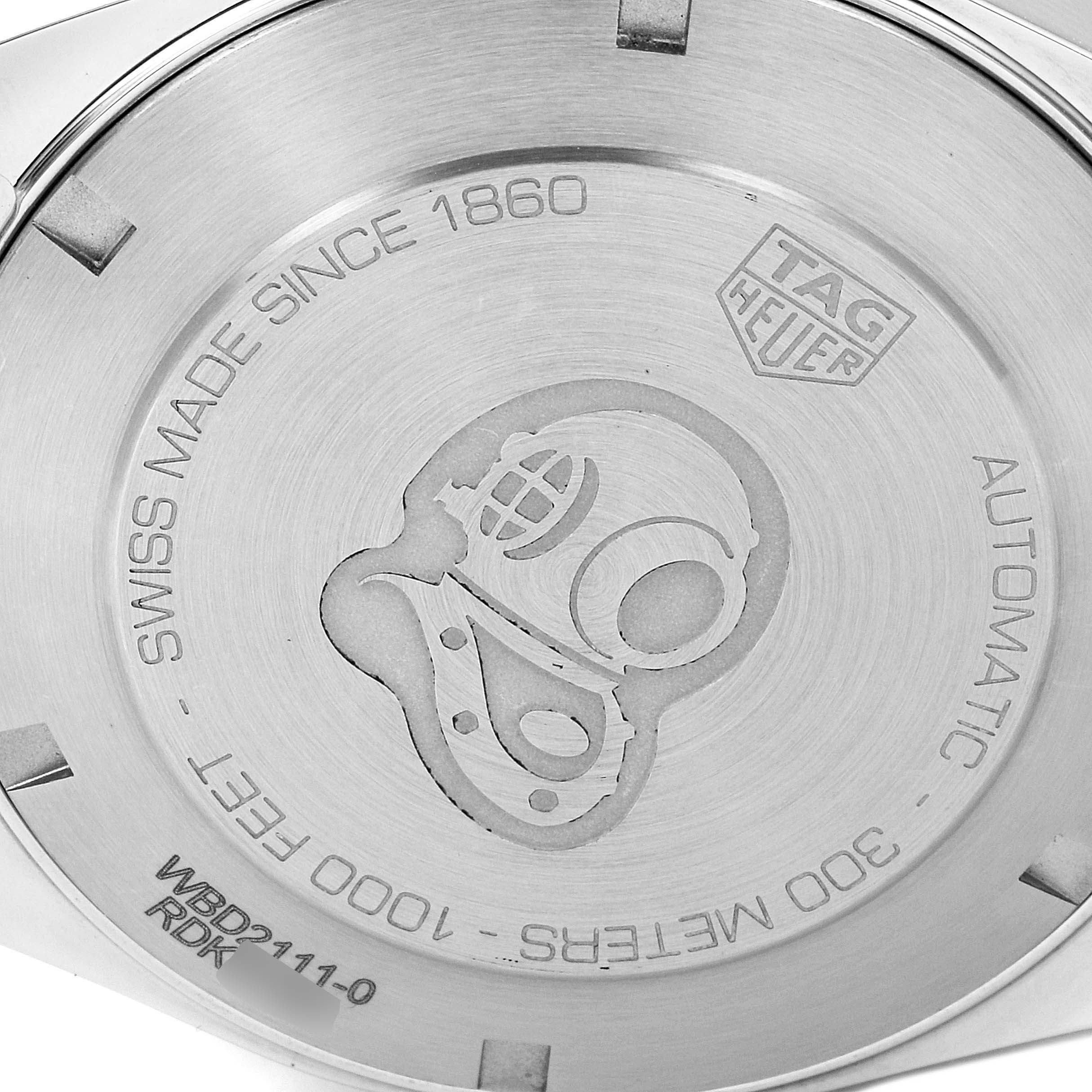The image shows the back case of a Tag Heuer Aquaracer WBD2111.BA0928 Men's Stainless Steel White Dial WBD2111.BA0928 Men's Stainless Steel White Dial watch, featuring engraved text and a diver helmet design.