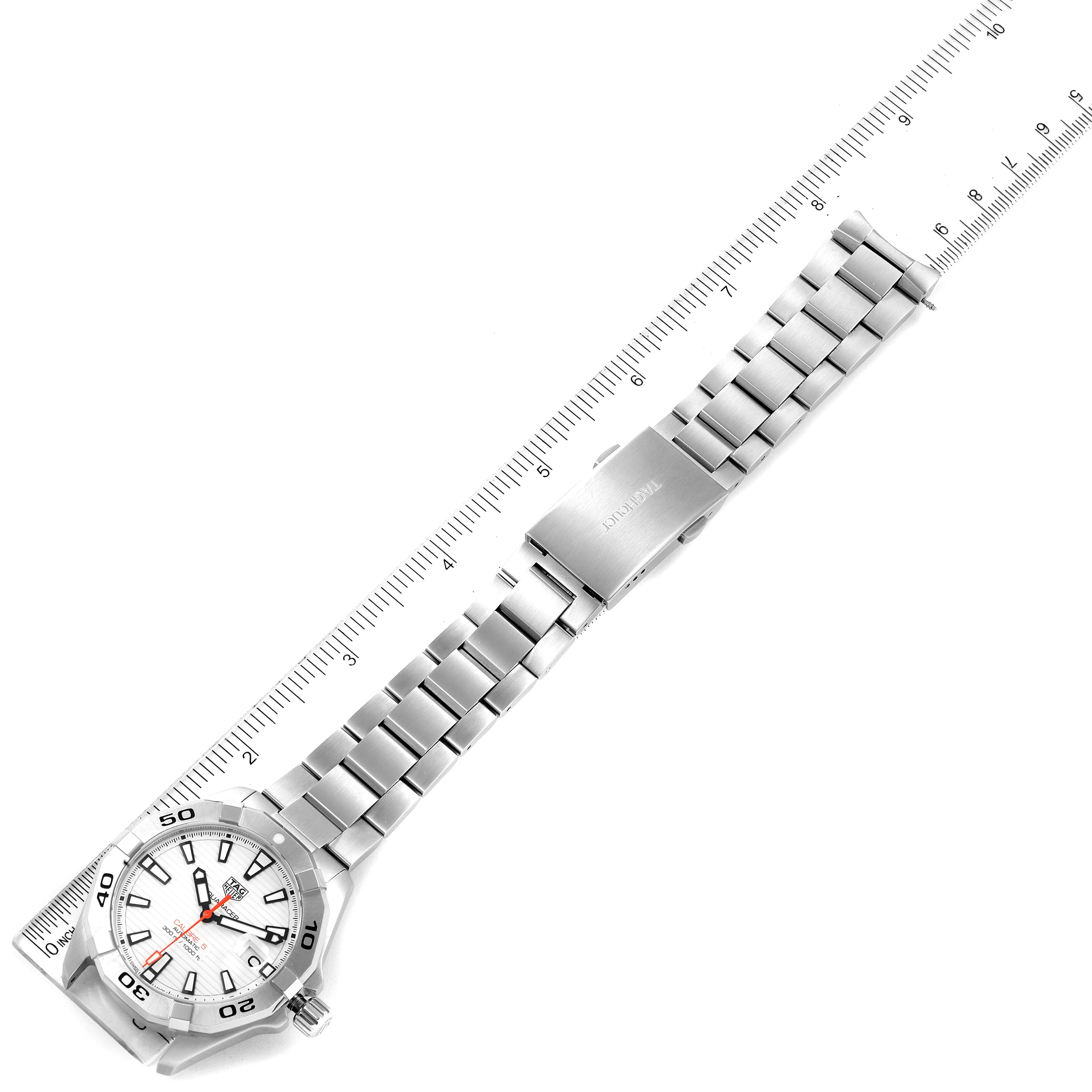 The Tag Heuer Aquaracer WBD2111.BA0928 Men's Stainless Steel White Dial WBD2111.BA0928 Men's Stainless Steel White Dial watch is shown laid flat with its stainless steel bracelet and clasp visible, alongside a ruler for scale.