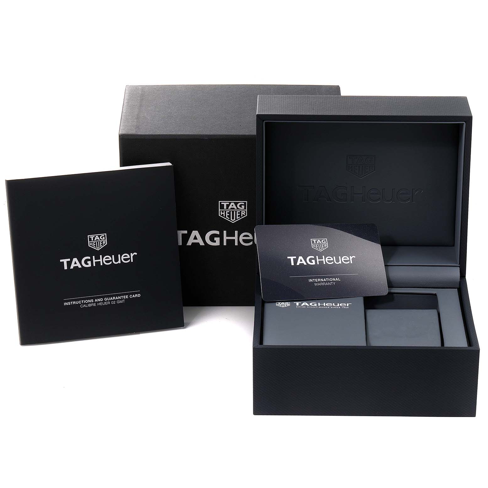 The image shows the packaging and accessories for the Tag Heuer Carrera CBG2A1Z.BA0658 Men
s Stainless Steel Black Dial CBG2A1Z.BA0658 Men
s Stainless Steel Black Dial watch, including the box, instruction manual, and warranty card.