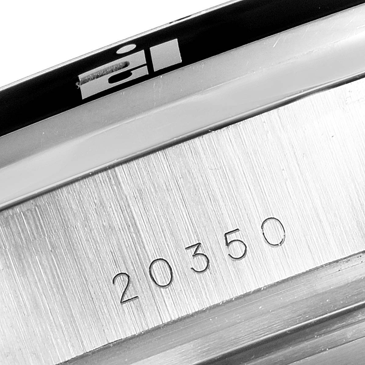 This image shows a close-up view of the serial number "20350" engraved on the case of a Tudor Grantour 20350N Men's Stainless Steel Black Dial 20350N Men's Stainless Steel Black Dial watch.